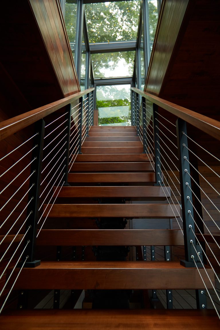 Clear coated treads and cable railing on floating stairs