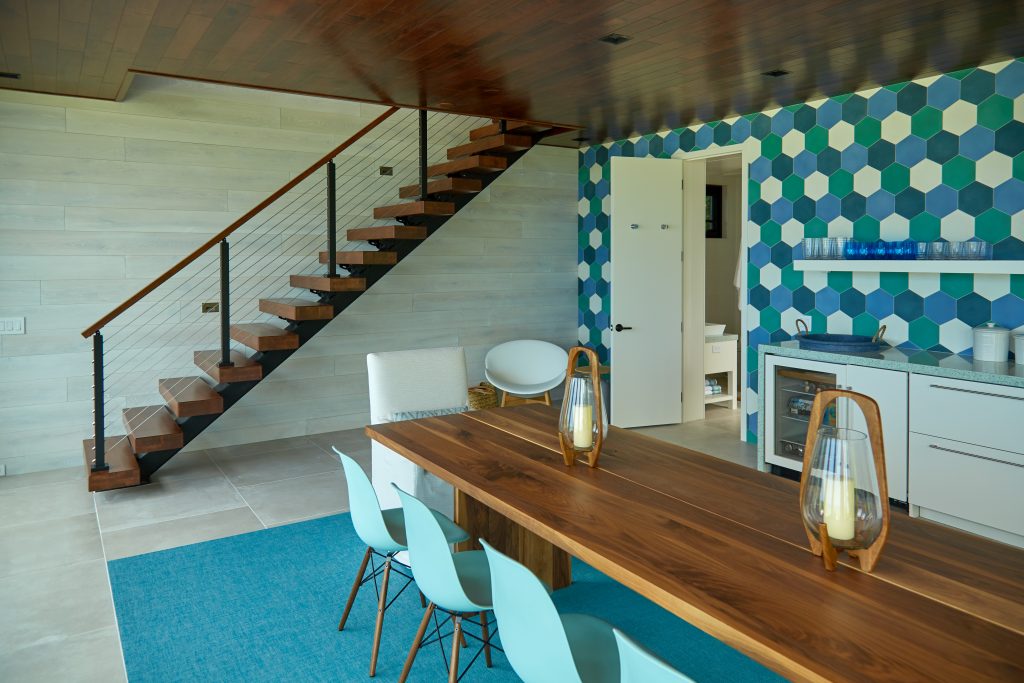 Wide shot of floating stairs in a modern kitchen with geometric patterned walls