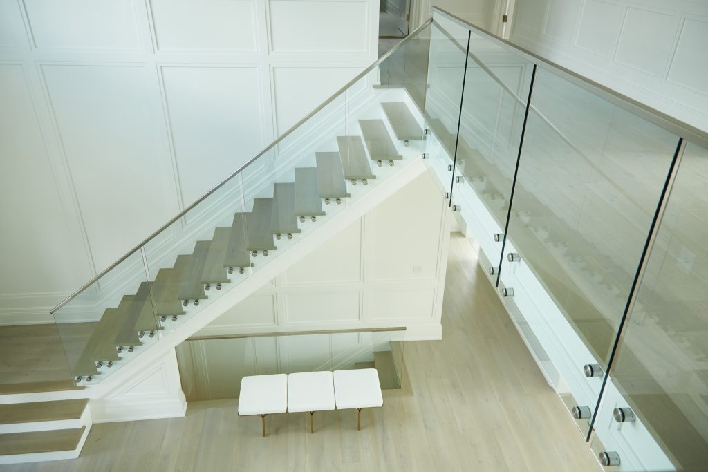 Above floating staircase with frameless glass railing