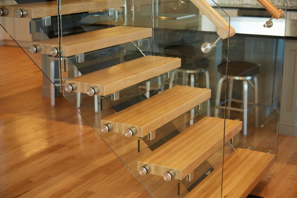 Stair treads with standoff pins and glass railing panels