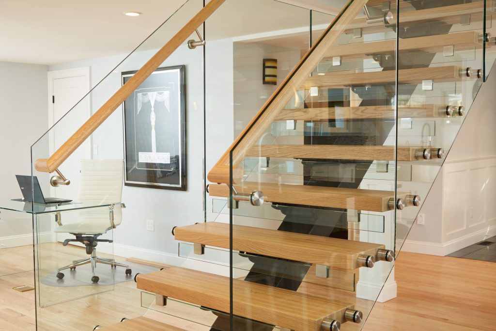 Floating staircase with glass railing in modern home