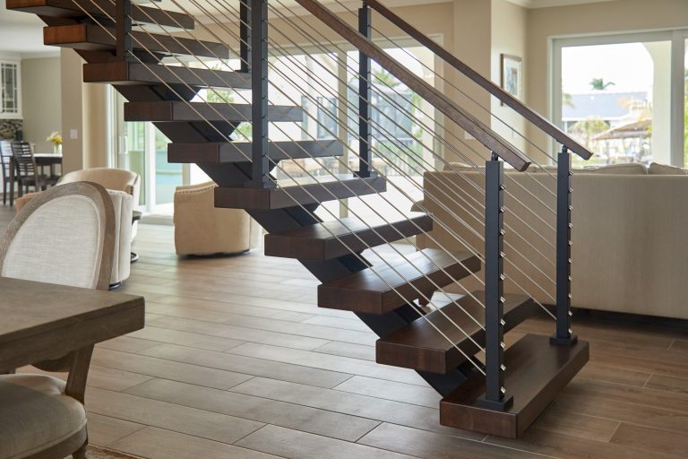 Floating stairs featuring stained white oak treads and rod railing.