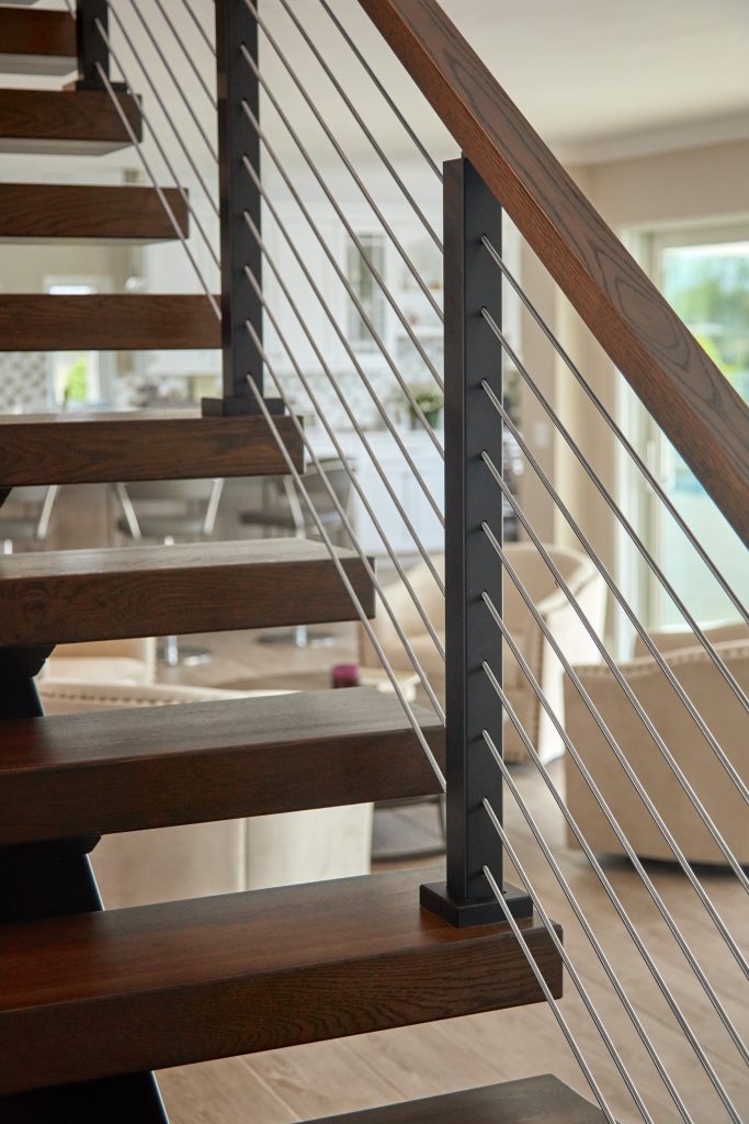 Close up of rod railing system on floating stairs.