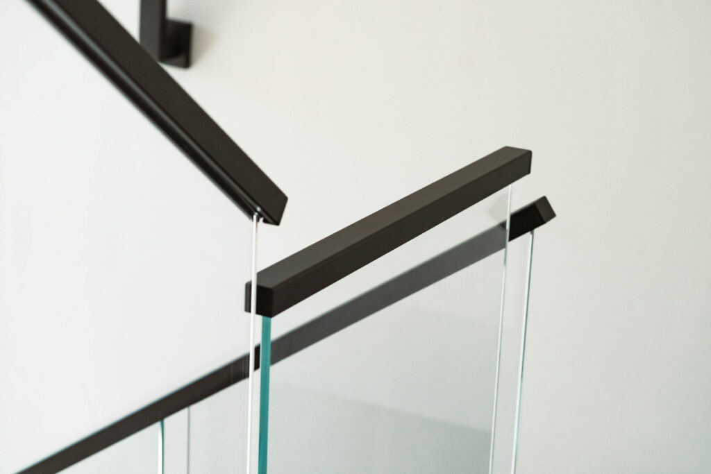 Glass Railing with Black Metal Handrail