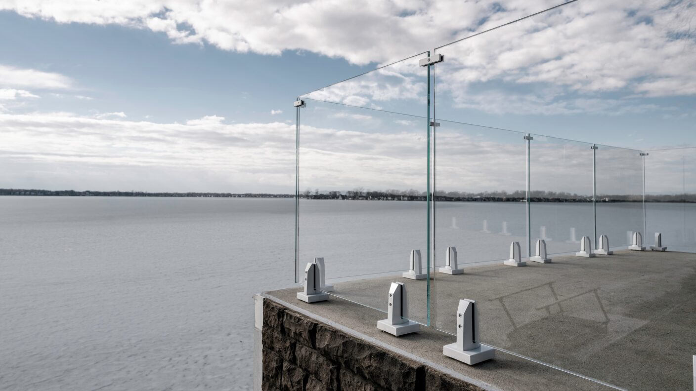 Glass Railing with White Accents looking over a Frozen Lake