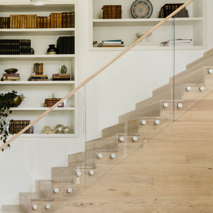 Glass Railing with a wooden handrail and white glass pins