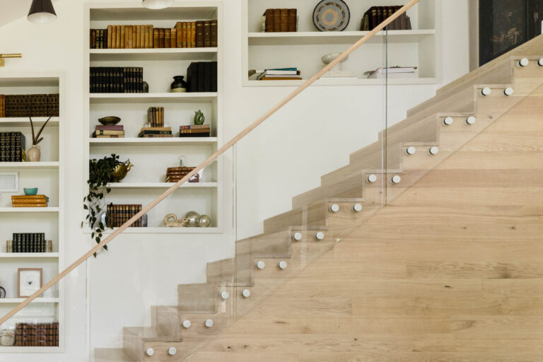 Glass Railing with a wooden handrail and white glass pins