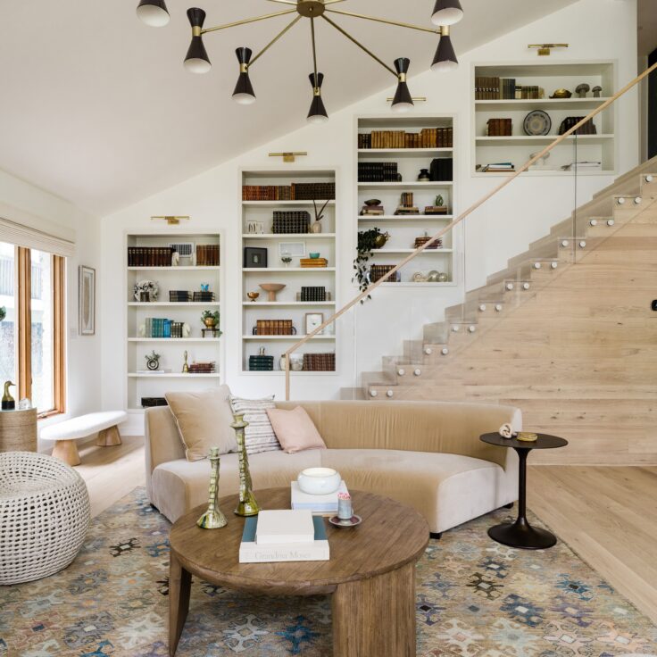 Glass Railing with Sandstone Pins in a Light, Bright Living Room