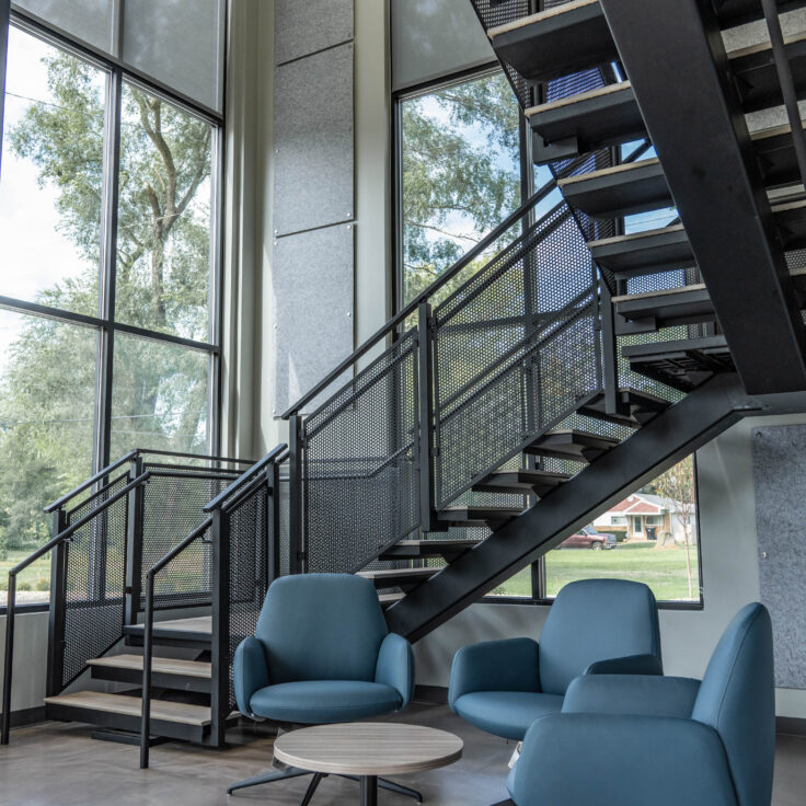 Floating Stairs made from Porcelain Treads and Perforated Railing Panels