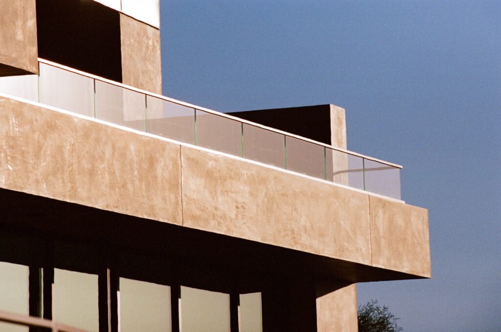 External view of a balcony and glass railing on the New American Home 2025