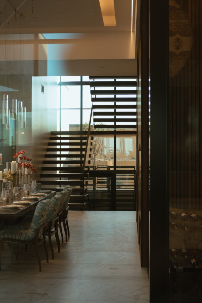 A view through the dining room of Viewrail FLIGHT Cantilever stairs installed in The New American Home 2025